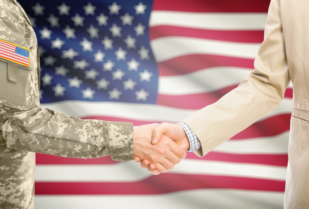 A military man shaking hand with a man
