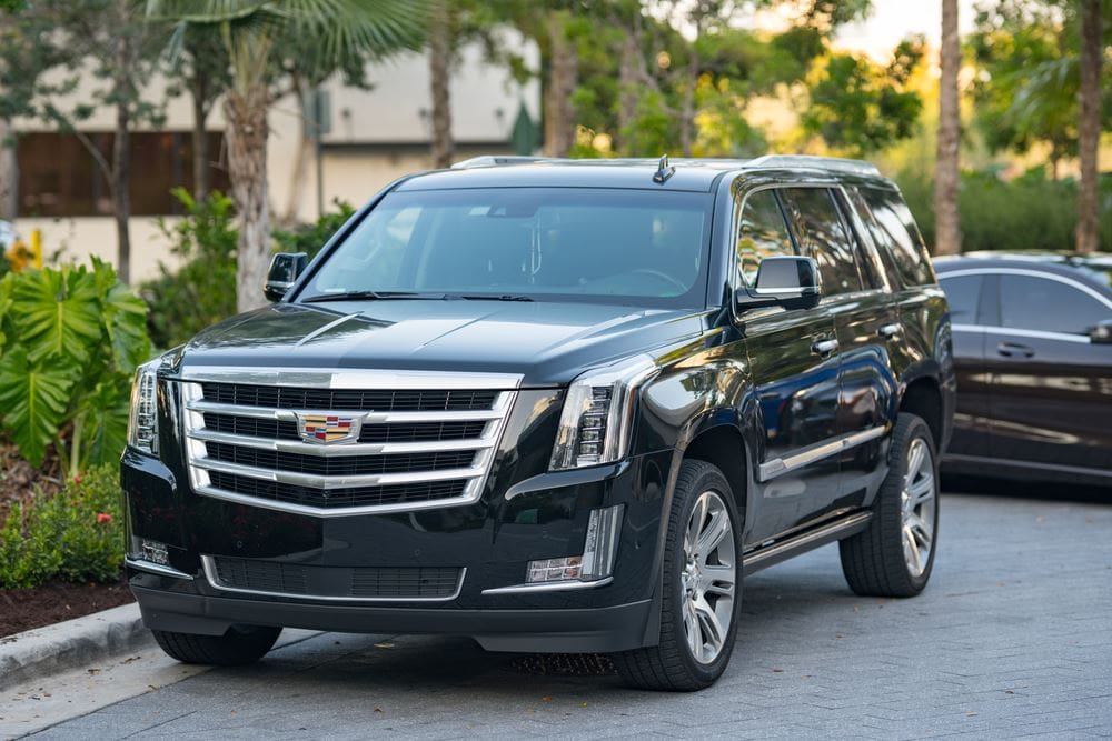 A black suv is parked on the street.