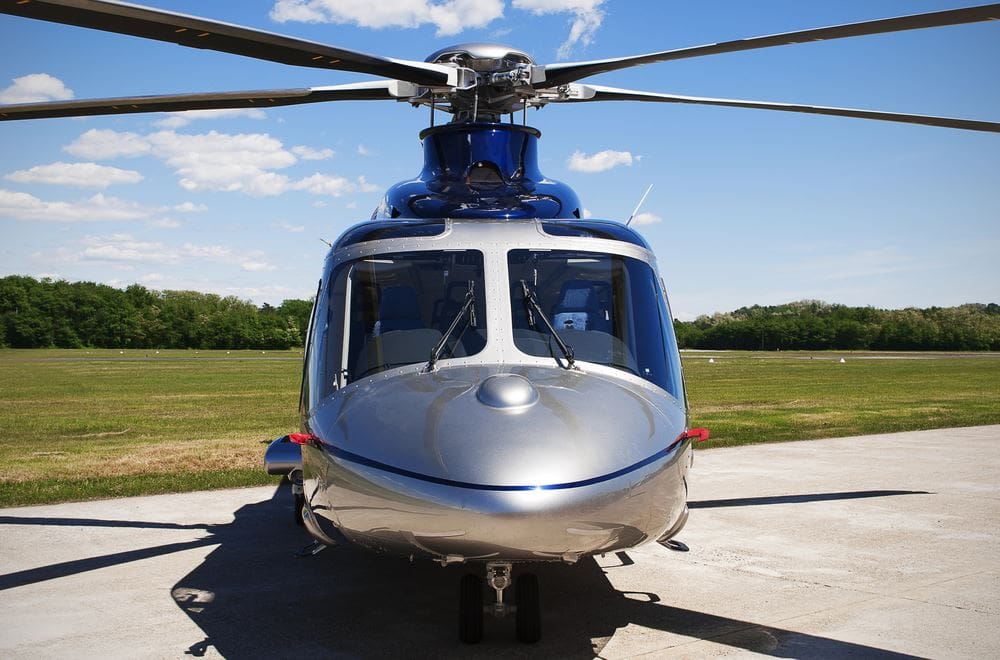 A helicopter sitting on top of an airport runway.