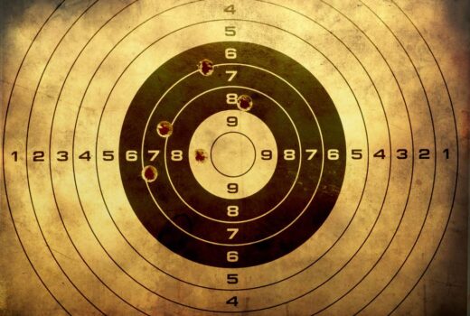 Gun range target with bullet holes