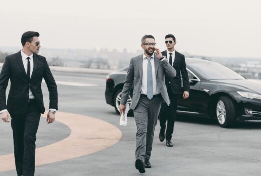 Personal protection officers walking with businessman